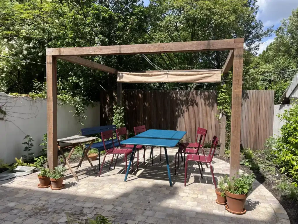 pergola utrecht met mooi terras en harmonica schaduwdoek